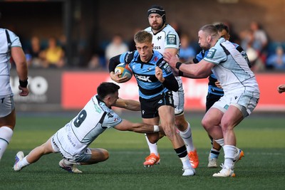 240426 - Cardiff Rugby v Ospreys - United Rugby Championship - Cam Winnett of Cardiff Rugby is challenged by Rueben Morgan-Williams of Ospreys