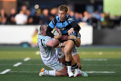 240426 - Cardiff Rugby v Ospreys - United Rugby Championship - Cam Winnett of Cardiff Rugby is challenged by Luke Morgan of Ospreys
