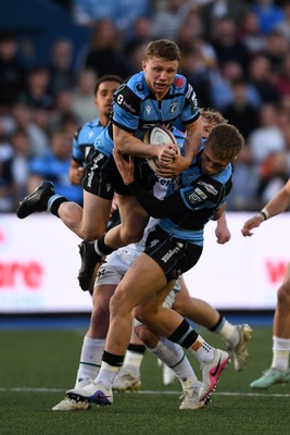 240426 - Cardiff Rugby v Ospreys - United Rugby Championship - Tom Bowen of Cardiff Rugby is challenged by Jac Morgan of Ospreys