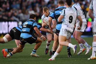 240426 - Cardiff Rugby v Ospreys - United Rugby Championship - Keiran Williams of Ospreys is challenged by Liam Belcher of Cardiff Rugby