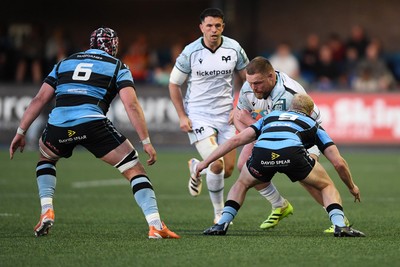 240426 - Cardiff Rugby v Ospreys - United Rugby Championship - Steffan Thomas of Ospreys is challenged by Johan Mulder of Cardiff Rugby