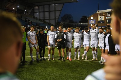 240426 - Cardiff Rugby v Ospreys - United Rugby Championship - Ospreys head coach, Mark Jones leads his sides huddle at full time