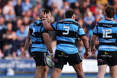 240426 - Cardiff Rugby v Ospreys - United Rugby Championship - Liam Belcher of Cardiff Rugby celebrates scoring a try with team mates