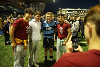 240426 - Cardiff Rugby v Ospreys - United Rugby Championship - Tom Bowen of Cardiff Rugby with fans at full time