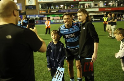 240426 - Cardiff Rugby v Ospreys - United Rugby Championship - Callum Sheedy of Cardiff Rugby with fans at full time
