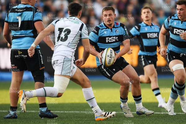 240426 - Cardiff Rugby v Ospreys - United Rugby Championship - Daf Huughes of Cardiff Rugby is challenged by Owen Watkin of Ospreys