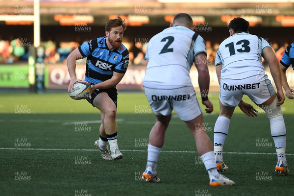 240426 - Cardiff Rugby v Ospreys - United Rugby Championship - Rory Thornton of Cardiff Rugby is challenged by Sam Parry of Ospreys