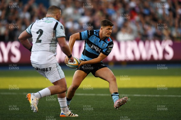 240426 - Cardiff Rugby v Ospreys - United Rugby Championship - Callum Sheedy of Cardiff Rugby is challenged by Sam Parry of Ospreys