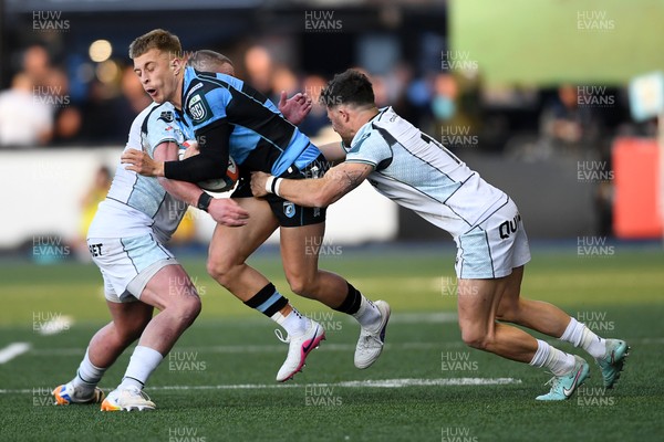 240426 - Cardiff Rugby v Ospreys - United Rugby Championship - Cam Winnett of Cardiff Rugby is challenged by Luke Morgan of Ospreys