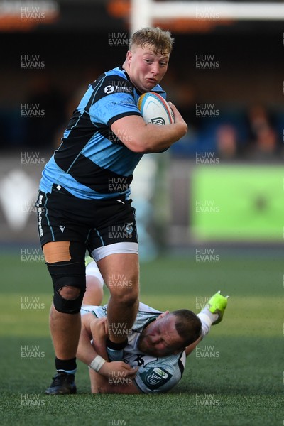 240426 - Cardiff Rugby v Ospreys - United Rugby Championship - Rhys Barratt of Cardiff Rugby is challenged by Steffan Thomas of Ospreys