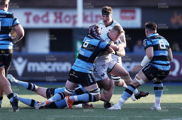 240426 - Cardiff Rugby v Ospreys - United Rugby Championship - Keiran Williams of Ospreys is tackled by Alun Lawrence of Cardiff Rugby