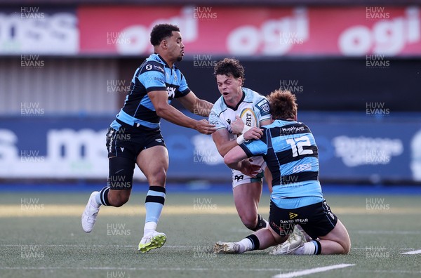 240426 - Cardiff Rugby v Ospreys - United Rugby Championship - Jack Walsh of Ospreys is tackled by Rory Jennings of Cardiff Rugby