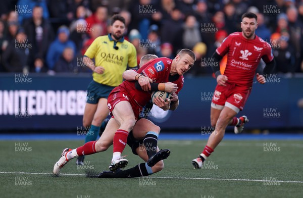 021223 - Cardiff Rugby v Scarlets - United Rugby Championship - Johnny McNicholl of Scarlets is tackled by Tinus de Beer of Cardiff 