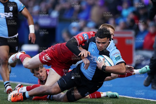 021223 - Cardiff Rugby v Scarlets - United Rugby Championship - Mackenzie Martin of Cardiff is tackled by Tom Rogers and Johnny McNicholl of Scarlets 