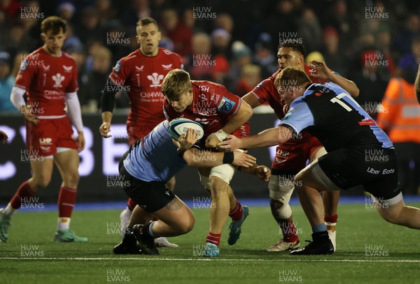 021223 - Cardiff Rugby v Scarlets - United Rugby Championship - Teddy Leatherbarrow of Scarlets is tackled by Rhys Carre of Cardiff 