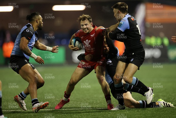 021223 - Cardiff Rugby v Scarlets - United Rugby Championship - Ioan Lloyd of Scarlets is tackled by Cameron Winnett of Cardiff 