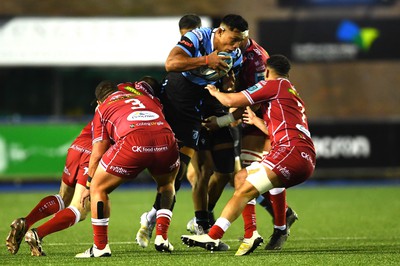 070123 - Cardiff v Scarlets - United Rugby Championship - Lopeti Timani of Cardiff is tackled by Javan Sebastian and Dan Davis of Scarlets