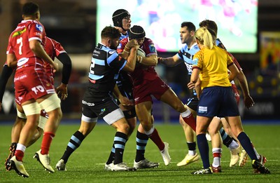 070123 - Cardiff v Scarlets - United Rugby Championship - Leigh Halfpenny of Scarlets is held by Kirby Myhill of Cardiff