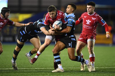 070123 - Cardiff v Scarlets - United Rugby Championship - Steff Evans of Scarlets is tackled by Mason Grady and Ben Thomas of Cardiff