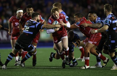 070123 - Cardiff Rugby v Scarlets - United Rugby Championship - Rhys Patchell of Scarlets is tackled by Kirby Myhill of Cardiff