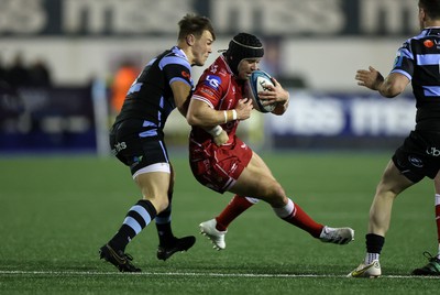 070123 - Cardiff Rugby v Scarlets - United Rugby Championship - Leigh Halfpenny of Scarlets is tackled by Jarrod Evans of Cardiff 