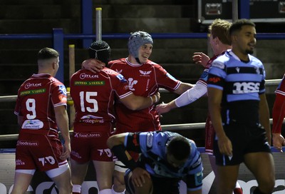 070123 - Cardiff Rugby v Scarlets - United Rugby Championship - Jonathan Davies of Scarlets celebrates scoring a try with team mates