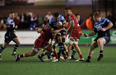 070123 - Cardiff Rugby v Scarlets - United Rugby Championship - Taulupe Faletau of Cardiff is tackled by Kemsley Mathias of Scarlets 