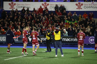 070123 - Cardiff Rugby v Scarlets - United Rugby Championship - Scarlets fans celebrate with the team at full time