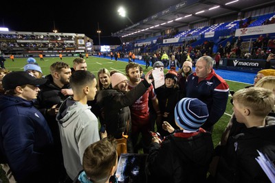 070123 - Cardiff Rugby v Scarlets - United Rugby Championship - Leigh Halfpenny of Scarlets takes pictures with fans