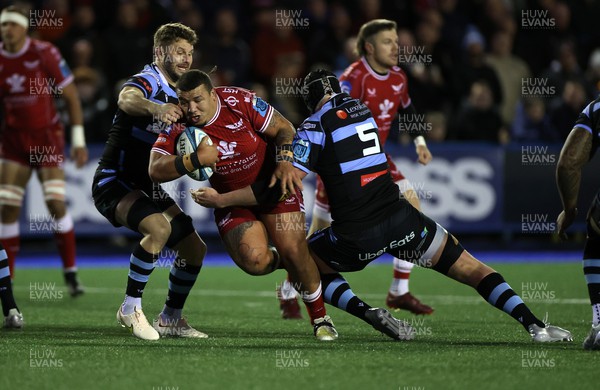 070123 - Cardiff Rugby v Scarlets - United Rugby Championship - Javan Sebastian of Scarlets is tackled by Thomas Young and Seb Davies of Cardiff