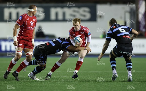 070123 - Cardiff Rugby v Scarlets - United Rugby Championship - Rhys Patchell of Scarlets is tackled by Lopeti Timani of Cardiff 