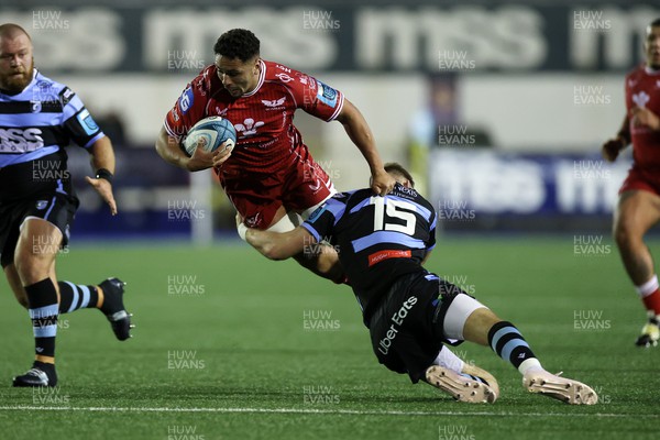 070123 - Cardiff Rugby v Scarlets - United Rugby Championship - Dan Davis of Scarlets is tackled by Liam Williams of Cardiff 