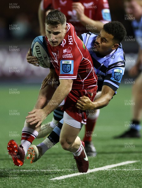 070123 - Cardiff Rugby v Scarlets - United Rugby Championship - Dane Blacker of Scarlets is tackled by Ben Thomas of Cardiff 