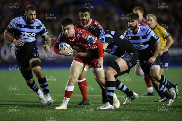 070123 - Cardiff Rugby v Scarlets - United Rugby Championship - Joe Roberts of Scarlets is tackled by Seb Davies of Cardiff