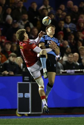 191225 - Cardiff Rugby v Scarlets - United Rugby Championship - Josh Adams of Cardiff and Ellis Mee of Scarlets go for the high ball