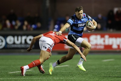 191225 - Cardiff Rugby v Scarlets - United Rugby Championship - Mason Grady of Cardiff is tackled by Eddie James of Scarlets 