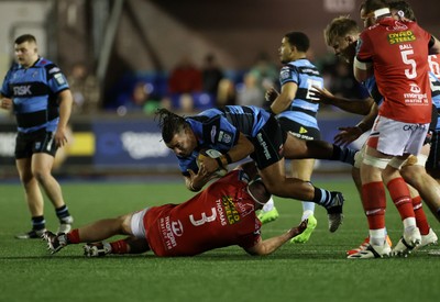 191225 - Cardiff Rugby v Scarlets - United Rugby Championship - Javan Sebastian of Cardiff is tackled by Henry Thomas of Scarlets 