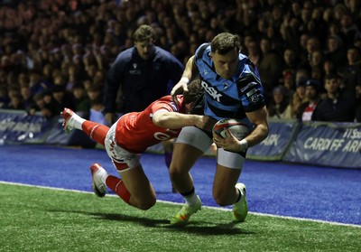 191225 - Cardiff Rugby v Scarlets - United Rugby Championship - Mason Grady of Cardiff gets past Eddie James of Scarlets to score a try