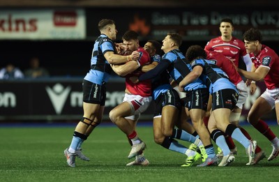 191225 - Cardiff Rugby v Scarlets, United Rugby Championship - Johnny Williams of Scarlets is held