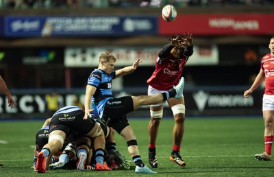 191225 - Cardiff Rugby v Scarlets, United Rugby Championship - Sam Lousi of Scarlets looks to charge down the kick from Aled Davies of Cardiff Rugby