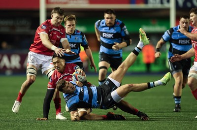 191225 - Cardiff Rugby v Scarlets, United Rugby Championship - Mason Grady of Cardiff Rugby is tackled by Sam Lousi of Scarlets