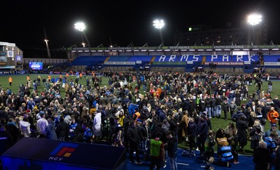 191225 - Cardiff Rugby v Scarlets, United Rugby Championship - Fans take to the Cardiff Arms Park pitch at the end of the match