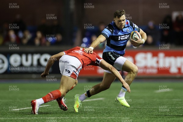 191225 - Cardiff Rugby v Scarlets - United Rugby Championship - Mason Grady of Cardiff is tackled by Eddie James of Scarlets 