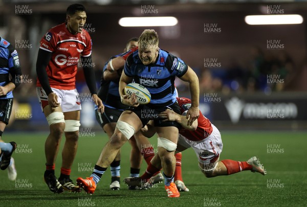 191225 - Cardiff Rugby v Scarlets - United Rugby Championship - Josh McNally of Cardiff is tackled by Kemsley Mathias of Scarlets 