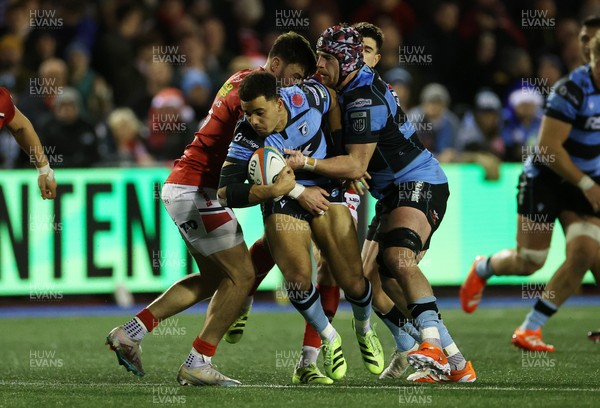 191225 - Cardiff Rugby v Scarlets - United Rugby Championship - Ben Thomas of Cardiff is tackled by Johnny Williams of Scarlets 