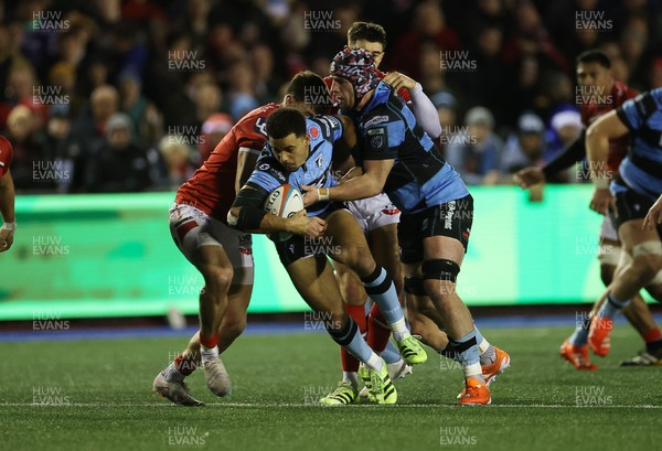 191225 - Cardiff Rugby v Scarlets - United Rugby Championship - Ben Thomas of Cardiff is tackled by Johnny Williams of Scarlets 