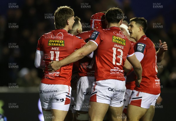 191225 - Cardiff Rugby v Scarlets - United Rugby Championship - Gareth Davies of Scarlets celebrates scoring a try with team mates