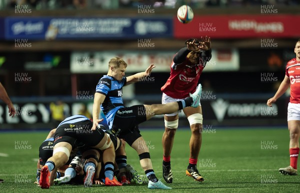 191225 - Cardiff Rugby v Scarlets, United Rugby Championship - Sam Lousi of Scarlets looks to charge down the kick from Aled Davies of Cardiff Rugby