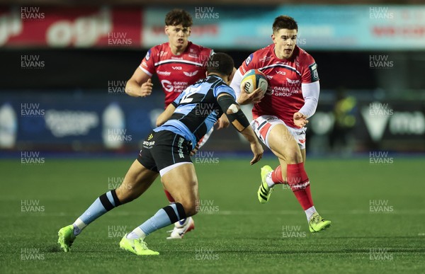 191225 - Cardiff Rugby v Scarlets, United Rugby Championship - Joe Hawkins of Scarlets takes on Ben Thomas of Cardiff Rugby