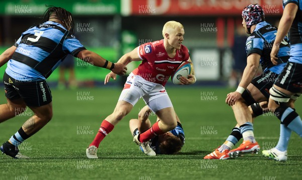 191225 - Cardiff Rugby v Scarlets, United Rugby Championship - Blair Murray of Scarlets is held as he looks to attack